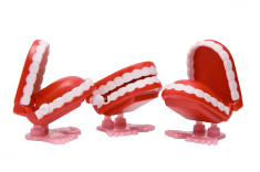stock-photo-955372-three-wind-up-chattering-teeth-toys-with-feet